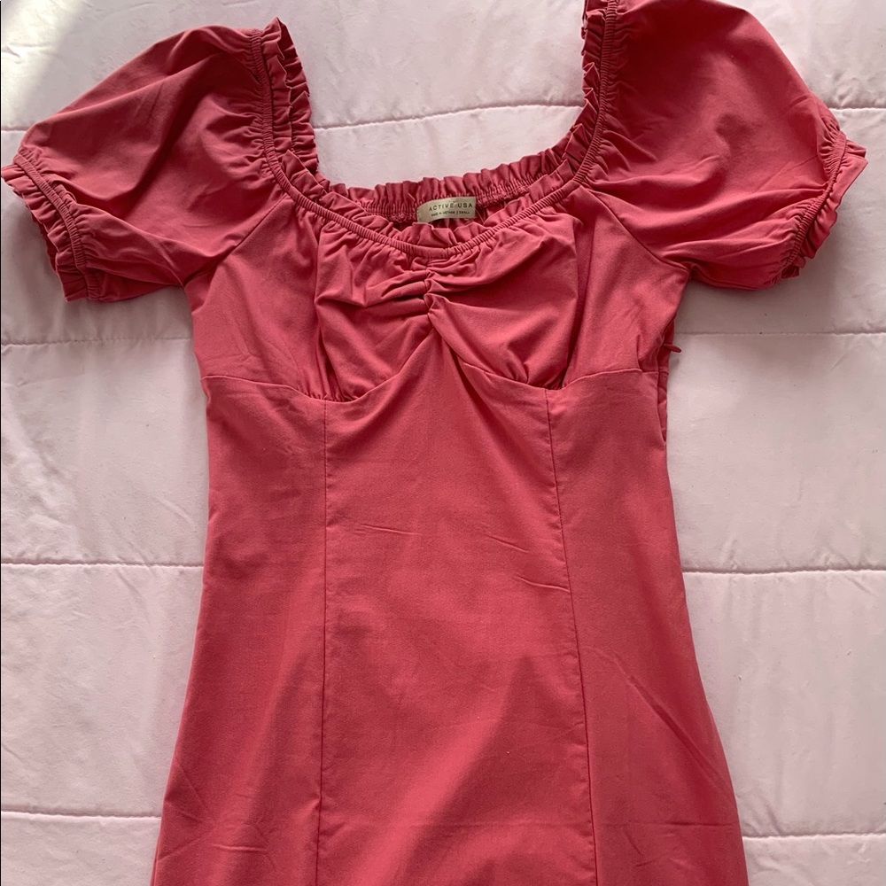 Pink bodycon dress with sleeves.